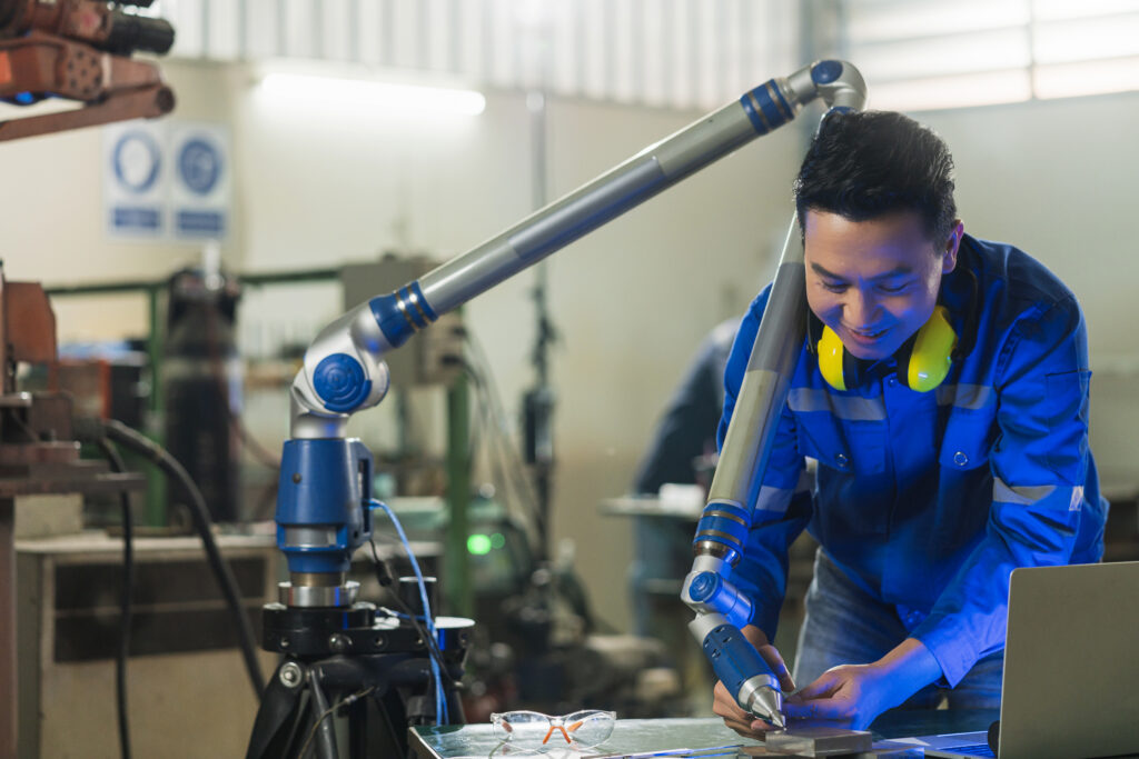 asian-male-engineer-specialist-with-measuring-machine-with-manipulator-armthreedimensional-coordinate-measurement-check-sizes-3d-check-sizes-parts-cmm-after-machining-process