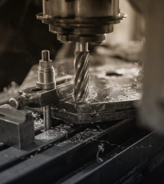 Industrial machine drilling metal.